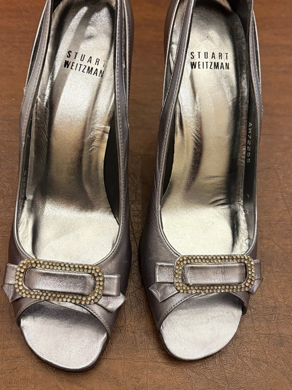 Stuart Weitzman Metallic Silver Peep-Toe Pumps with Jeweled Buckle. Size 7B